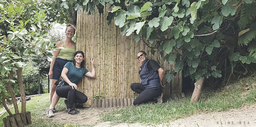 Workaway-volunteers-standing-in-front-bamboo-wall