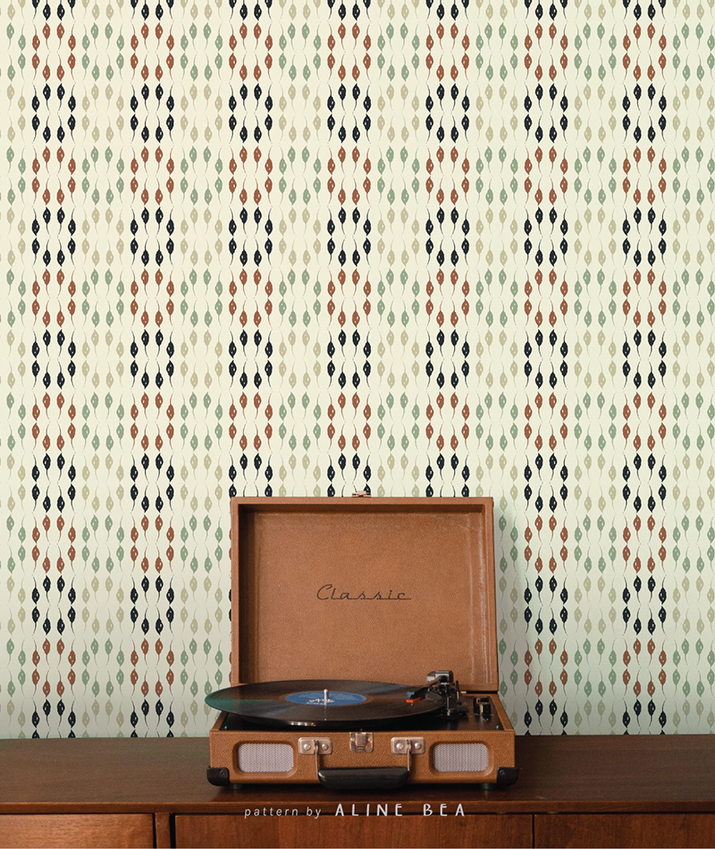 Wooden record player over a cabinet in front of a wall with abstract wallpaper design by Aline Bea