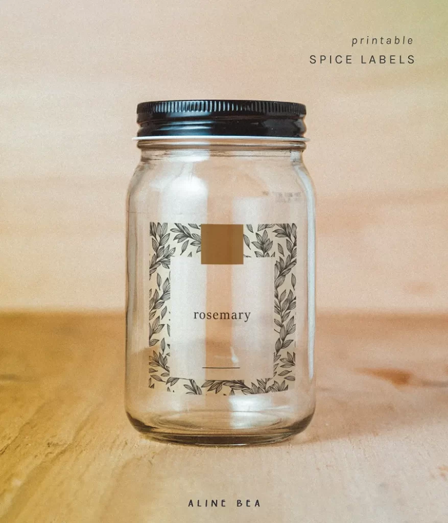 Spice jar with label rosemary designed by Aline Bea printed on transparent adhesive paper.