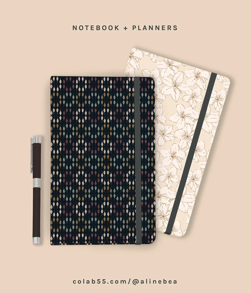 Set of two notebooks with decorative patterns on their covers. The notebook on top has a geometric and colorful pattern over a dark background. The notebook below has a delicate floral design in light colors.