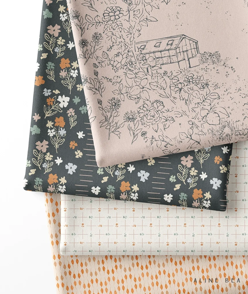 Four folded fabrics stacked on top of each other, displaying an abstract geometric design on bottom, followed by a minimalist plaid design, a floral design and a toile de juoy design on top.