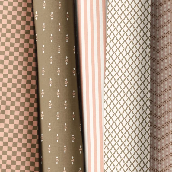 Fabric rolls displaying Aline Bea's designs from Summer Romance Collection. From left to right: a floral fabric, a checkered fabric, a minimalist floral, a striped fabric, a geometric fabric and a zig zag floral.