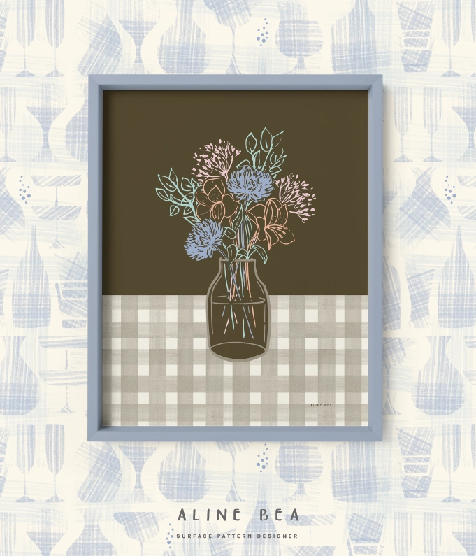 Framed art print with a hand-drawn vase with flowers hanged on a wall covered by a matching wallpaper.