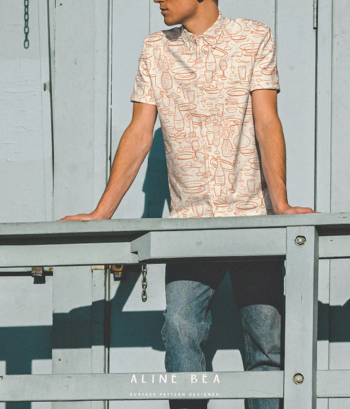 Guy wearing a shirt with a pattern that represents bottles, drinking glasses and other dinnerware.