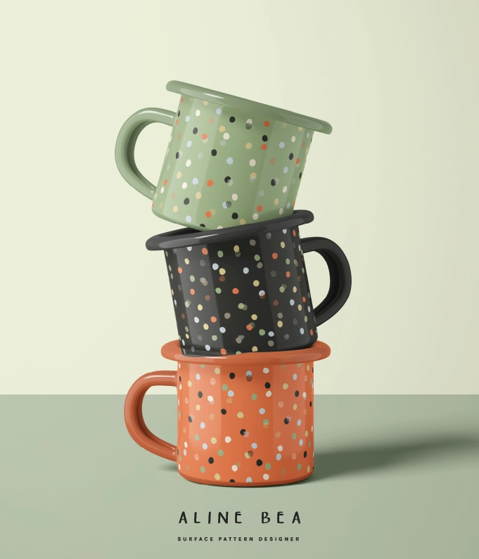 Three enamel mugs on top of each other with designs from Celebrate pattern collection.