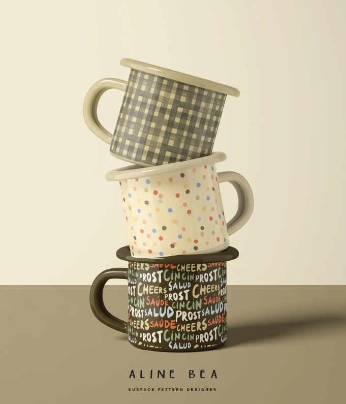 Three enamel mugs on top of each other with designs from Celebrate pattern collection. The first has a gingham design, the second a polka dot, and the third is a semaless pattern with capitalized letters with words Cheers, Salud, Prost, Cin Cin.