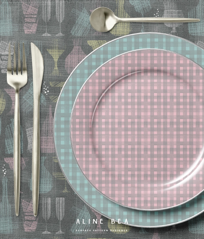 Two festive plates stacked on a table over colorful table cloth.