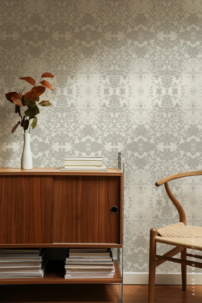 Grey and ivory lace-pattern wallpaper with a symmetrical damask motif in a living room