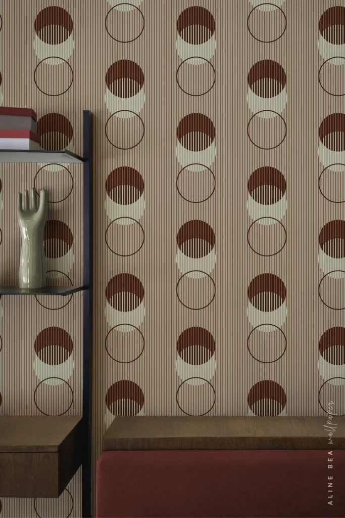 Rust and cream striped wallpaper with circular moon-phase motifs behind a bookshelf