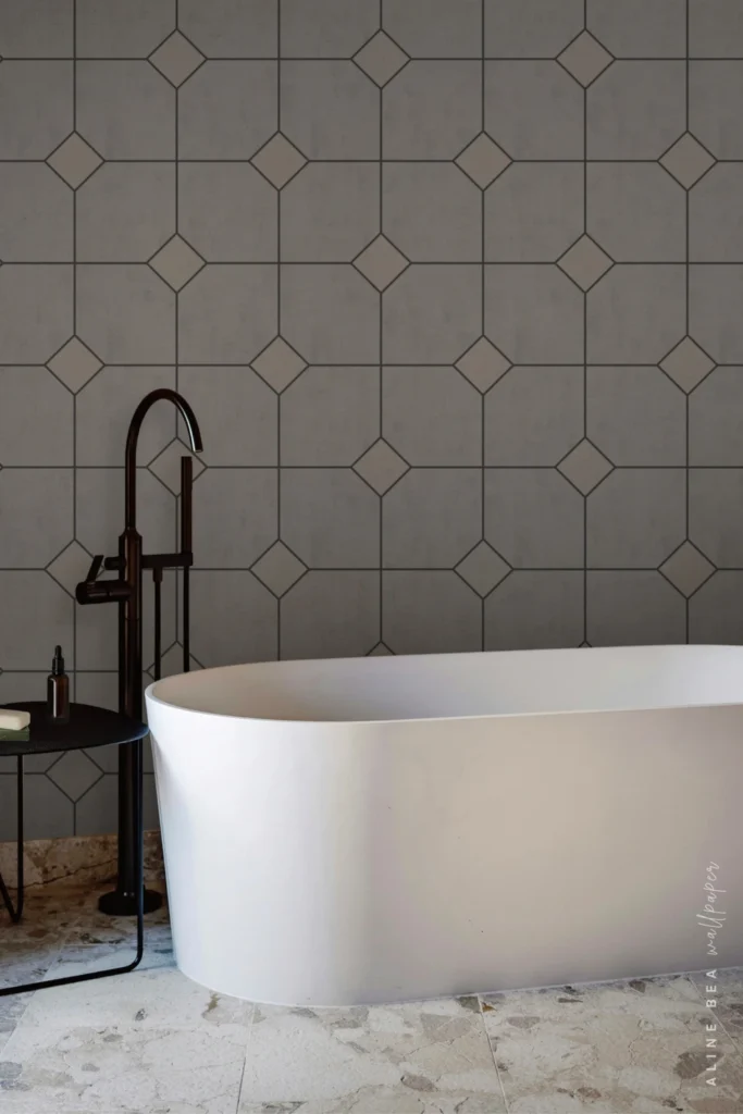 Grey diamond trellis tile-pattern wallpaper in a bathroom behind a freestanding tub