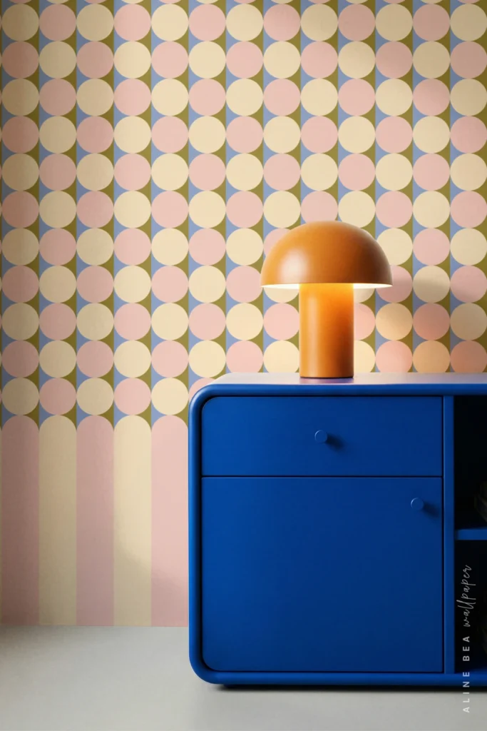 Pink, blue, and olive scalloped arch pattern wallpaper behind a blue credenza