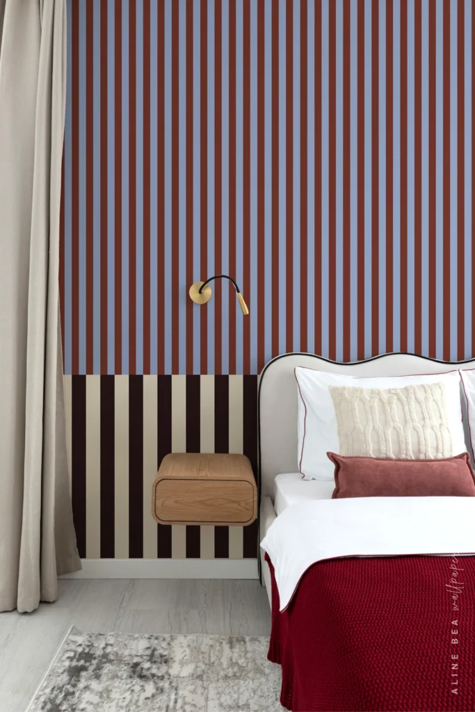 Rust and periwinkle blue striped wallpaper with a maroon and cream border in a bedroom