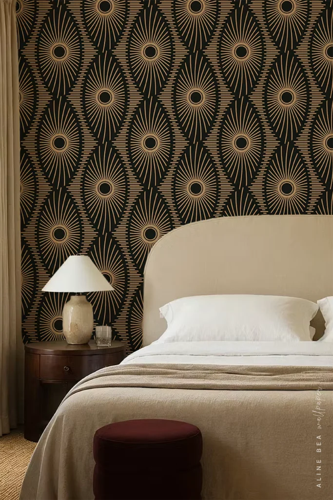 Black wallpaper with tan sunburst motifs in an ogee pattern behind a cream upholstered headboard in a bedroom